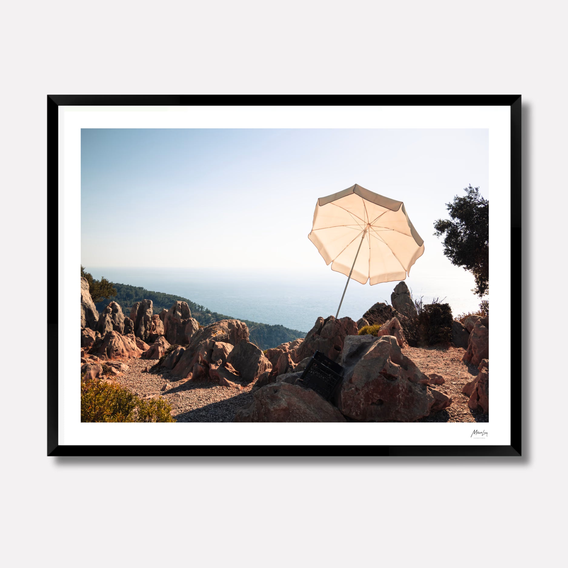 Fine art photography titled 'Cream' by Venturer Studios, featuring a solitary cream-colored umbrella on a serene coastal beach in Western Turkey. The minimalist landscape is presented in a premium black gallery frame.
